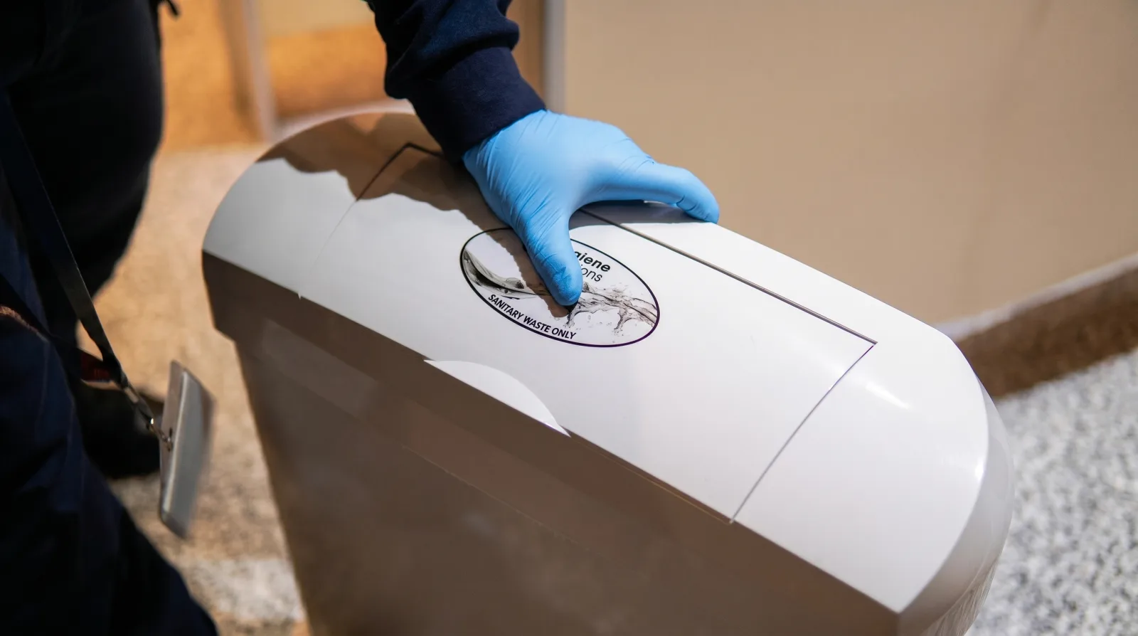 Hygiene Solutions engineer opening a sanitary bin during a service visit