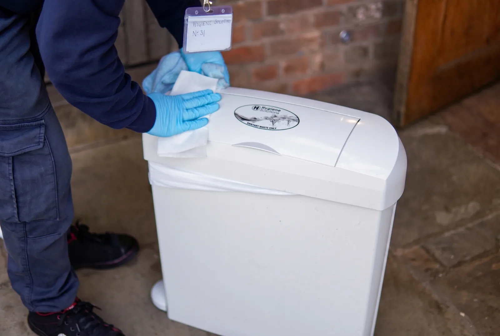 Hygiene Solutions operative servicing a washroom sanitary bin
