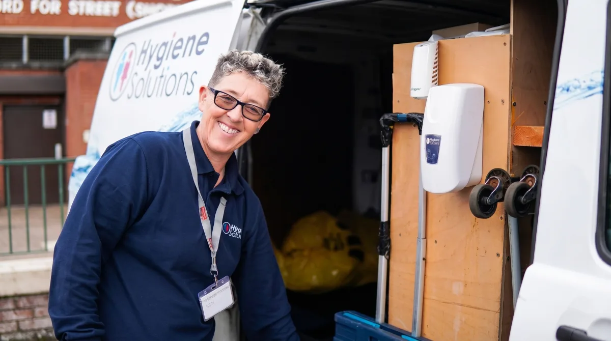 Hygiene Solutions engineer at a service van stocked with air care and washroom units